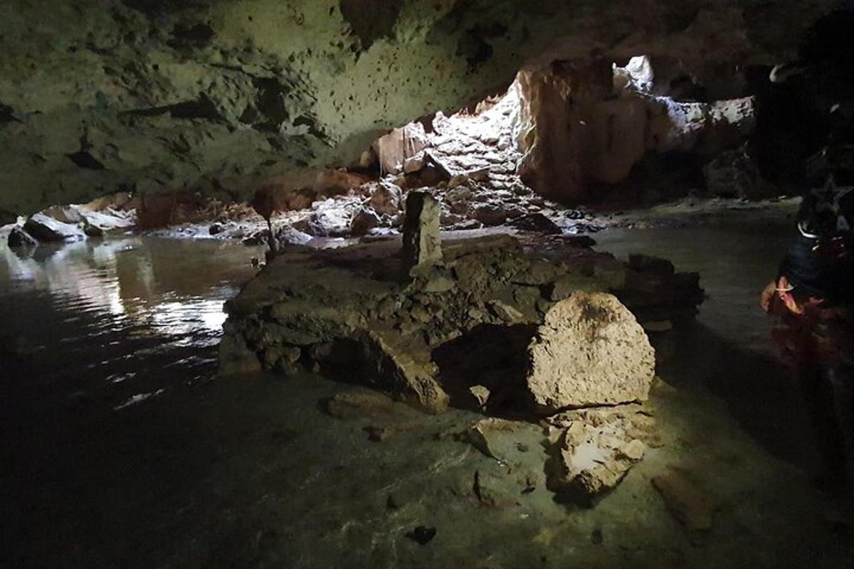a cave with some water and rocks in it