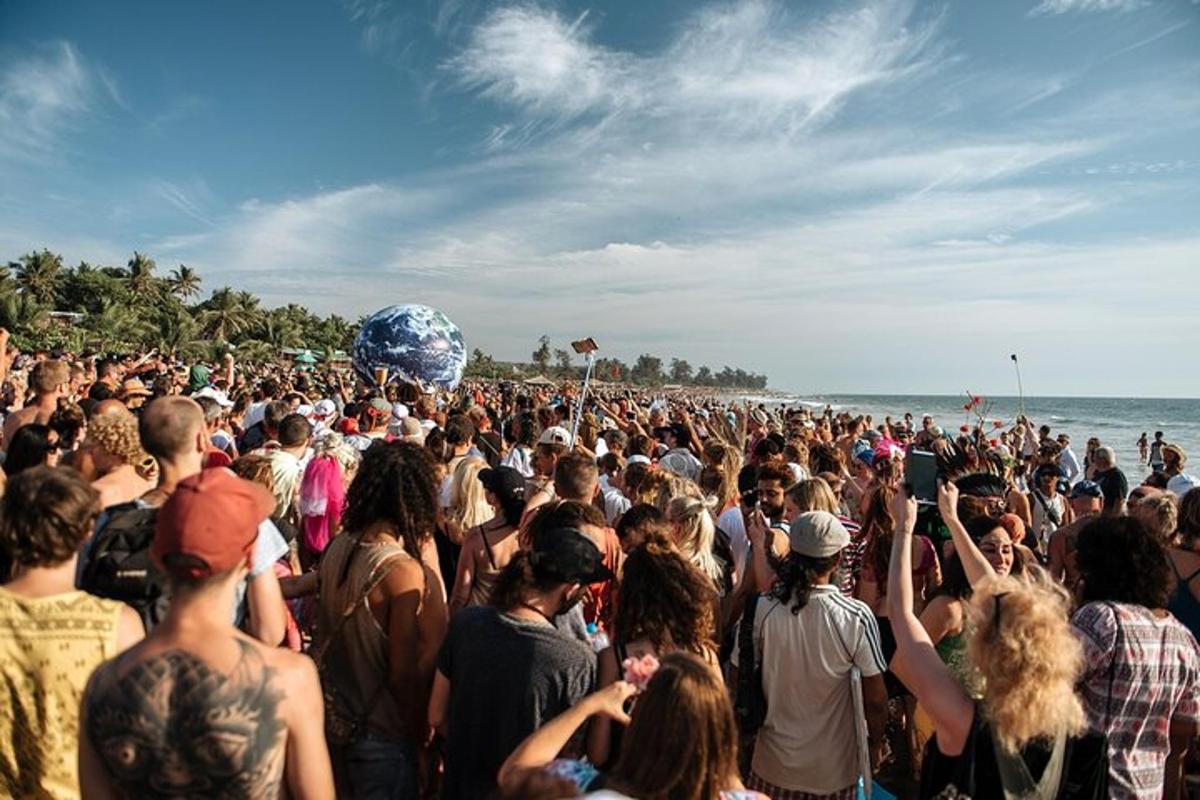 a large crowd of people standing on the beach