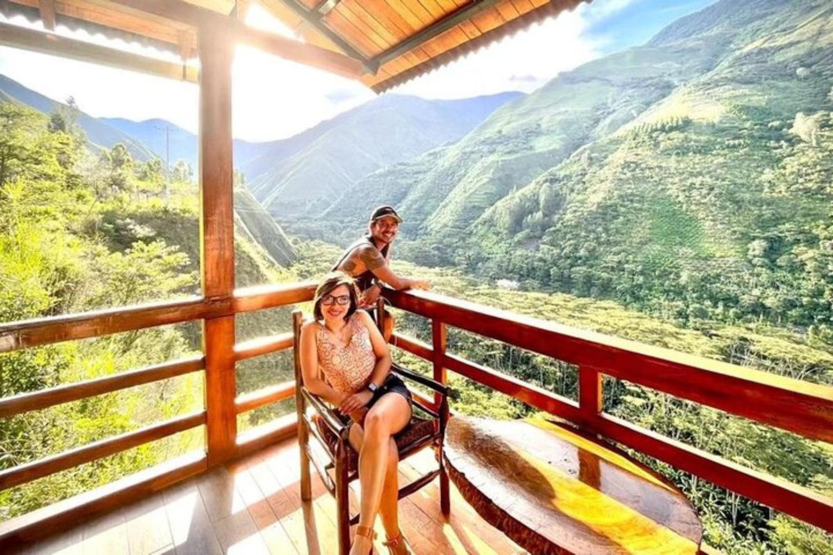 a man and a woman sitting on a balcony with a view