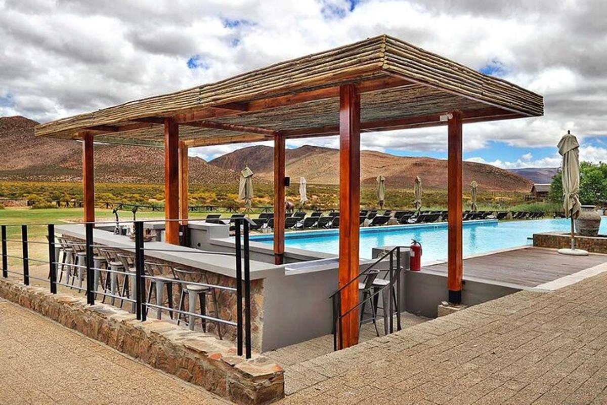 a swimming pool with a pavilion next to a swimming pool