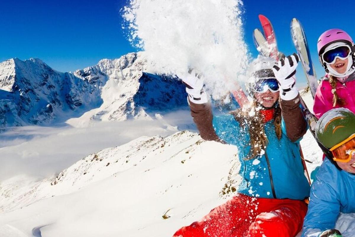 two people are sitting in the snow with their skis