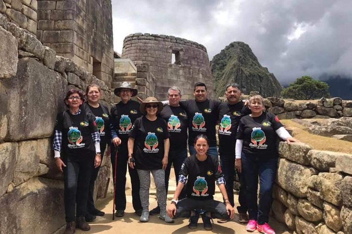 a group of people posing for a picture on a wall