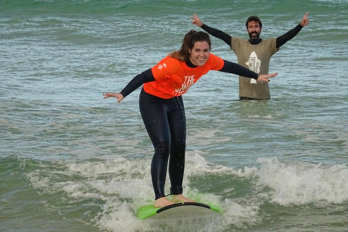 una dona cavalcant una onada sobre una taula de surf a l'oceà