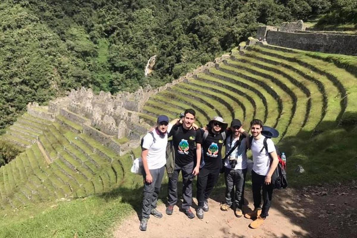 a group of men standing in front of an amphitheater