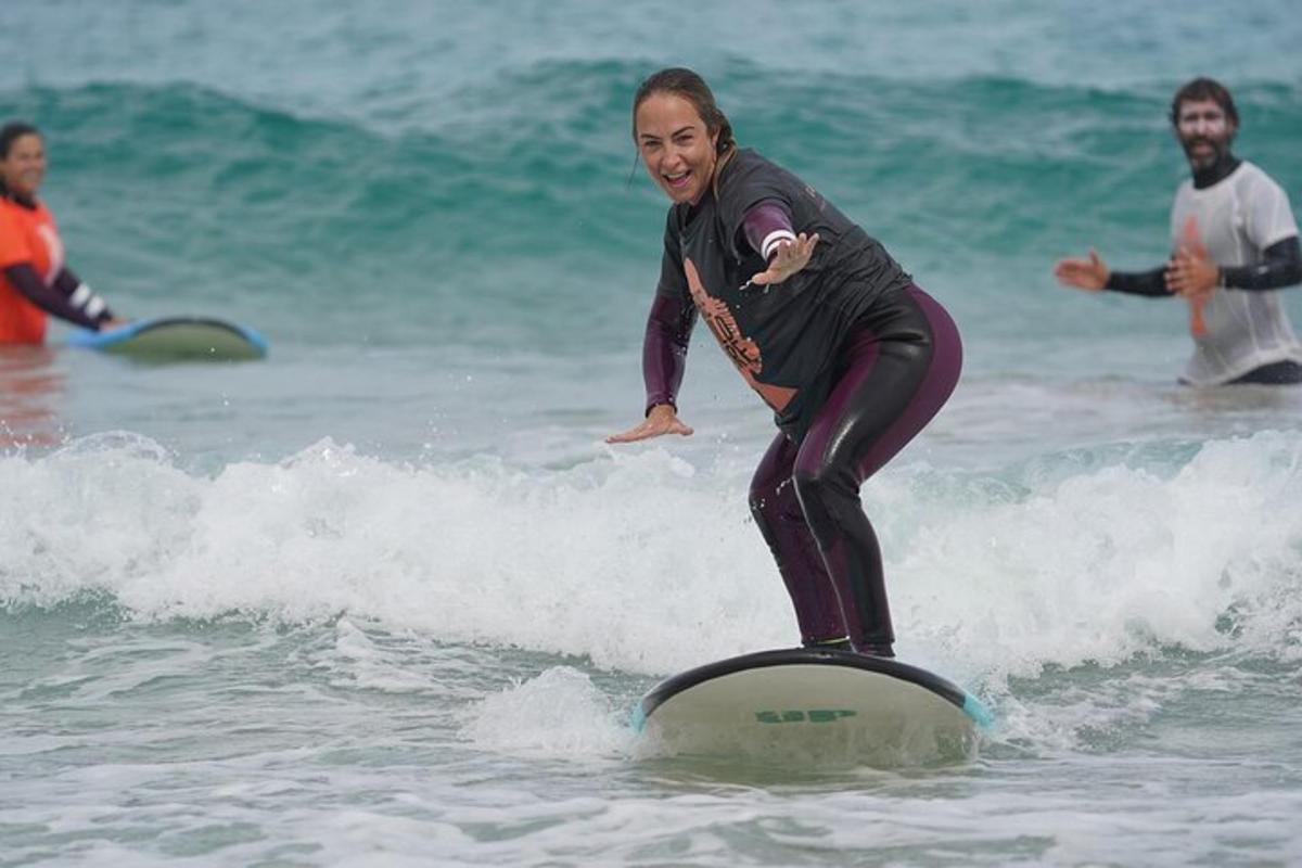 a woman riding a wave on a surfboard in the ocean