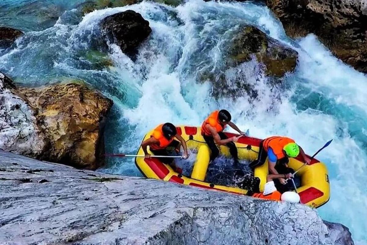 a group of people on a raft in a waterfall