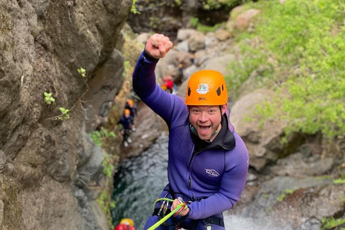 a man in an orange helmet is on a raft