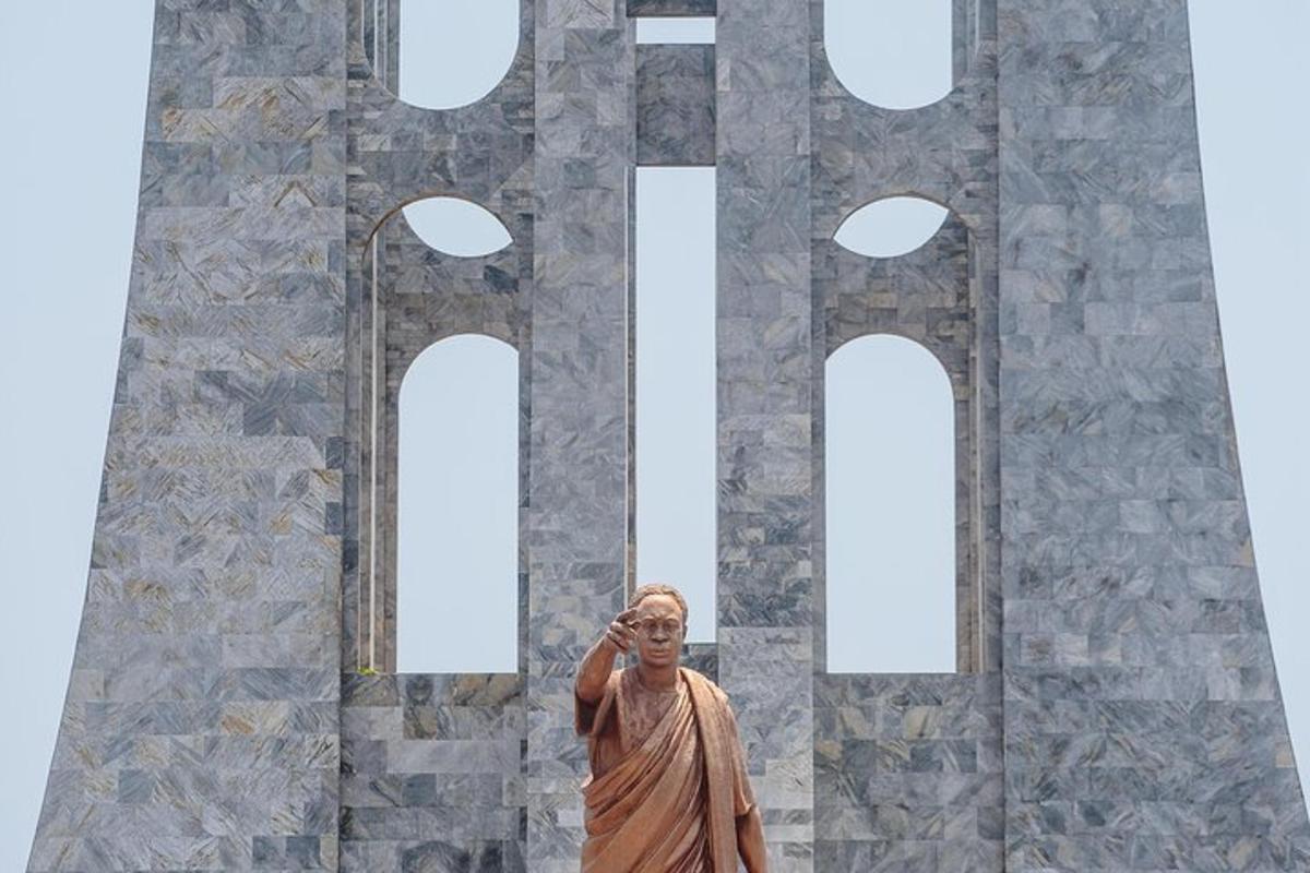 a statue of a man standing in front of a building