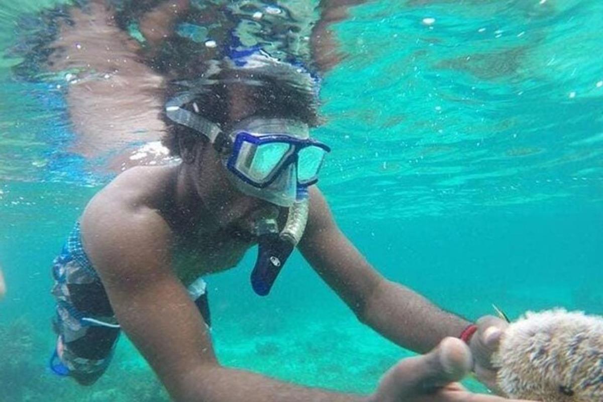 un ragazzino in acqua con un cane