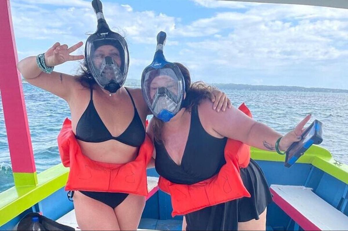 two women in costumes on a boat in the water