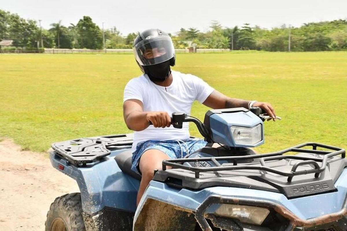 a man wearing a helmet riding on a four wheeler