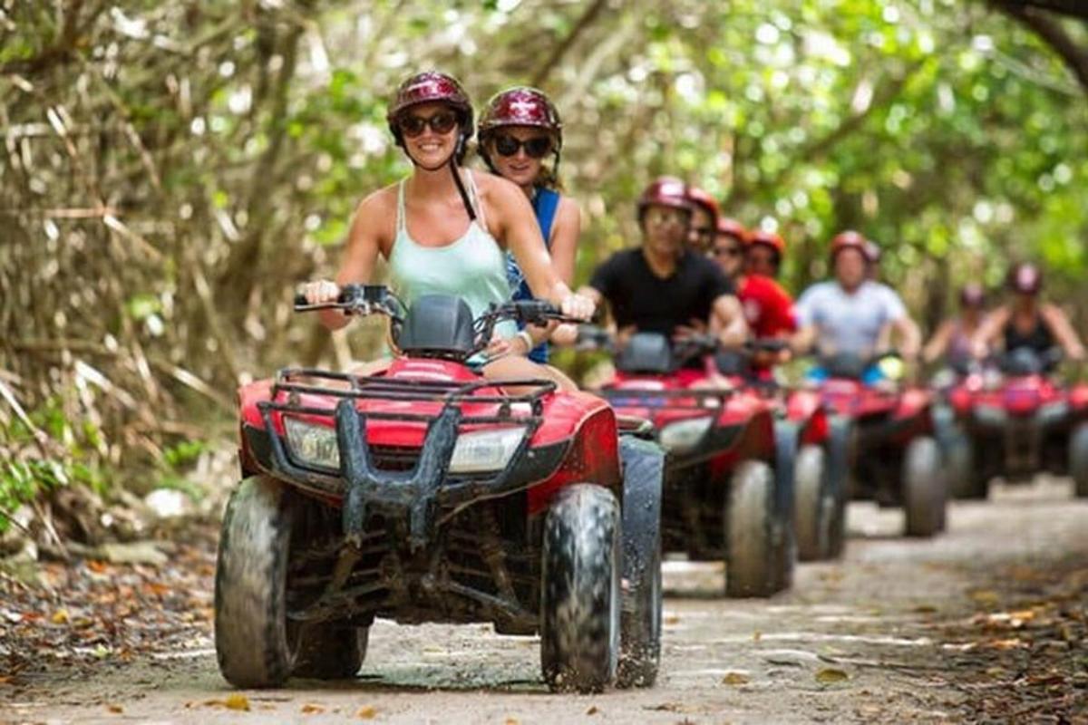 a group of people riding on four wheelers on a trail