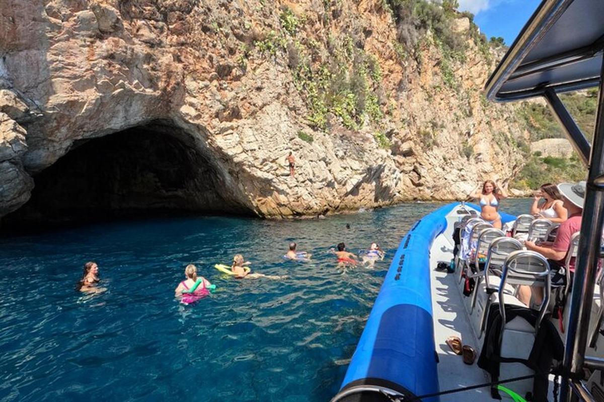 a group of people swimming in the water on a boat