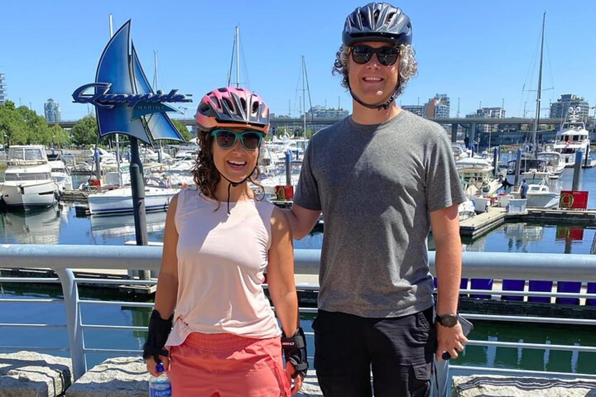 a man and a woman standing next to a marina