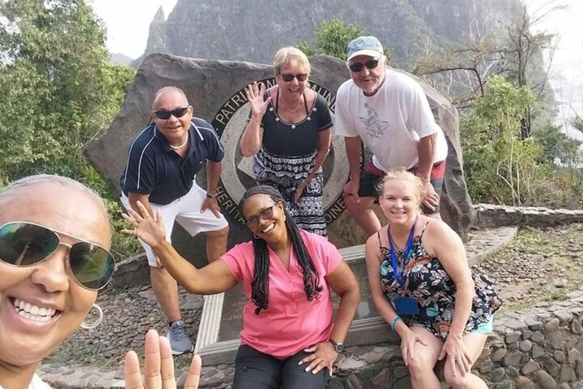 a group of people posing for a picture at the top of a mountain