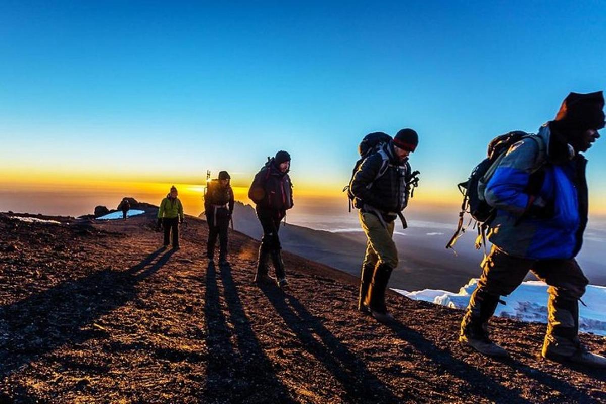 sekumpulan orang berjalan di sisi gunung