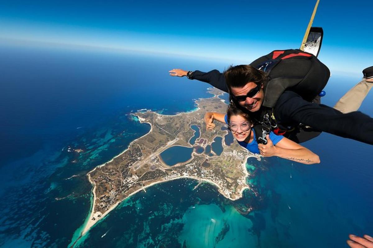 a man and a woman flying in the air over the ocean