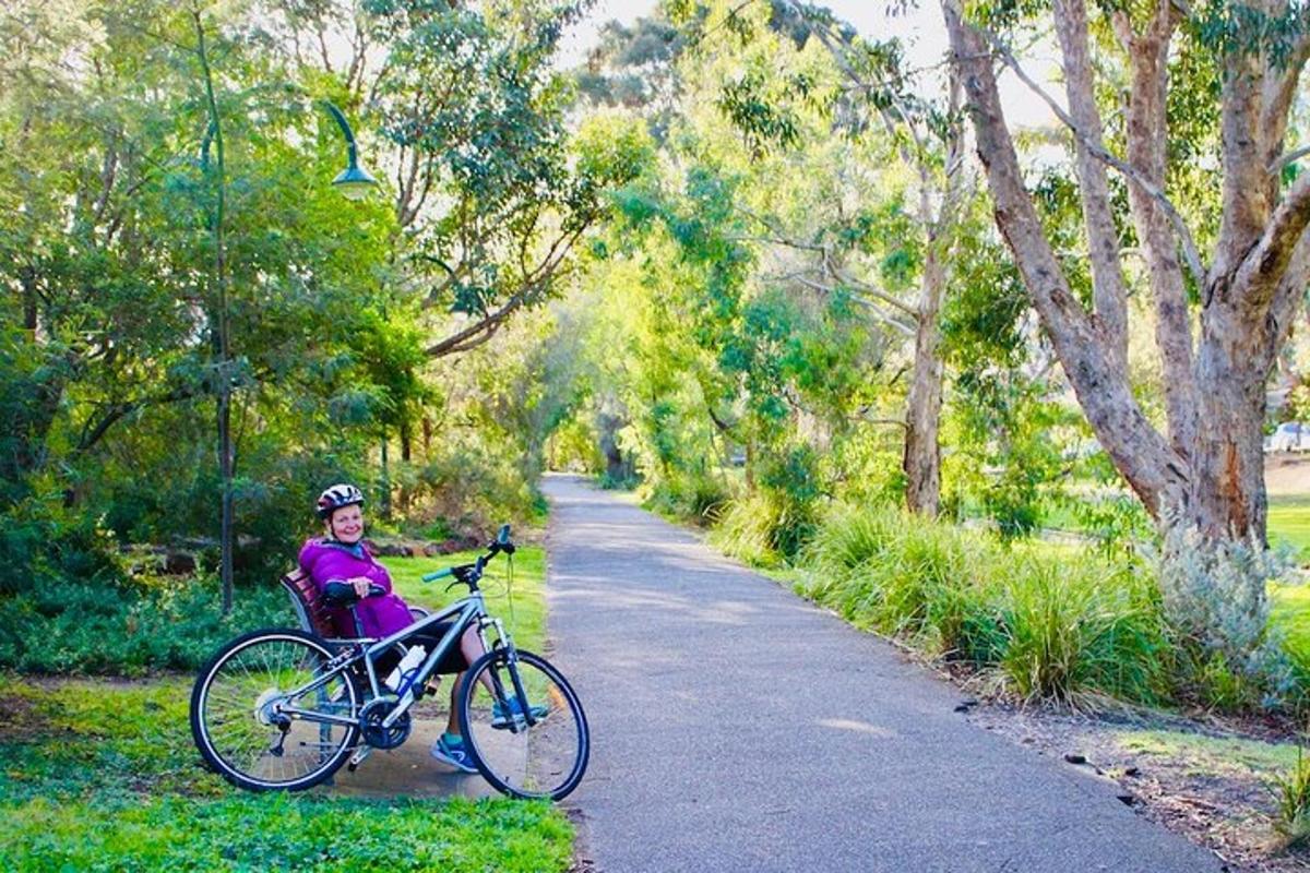 a woman sitting on a bike on a path