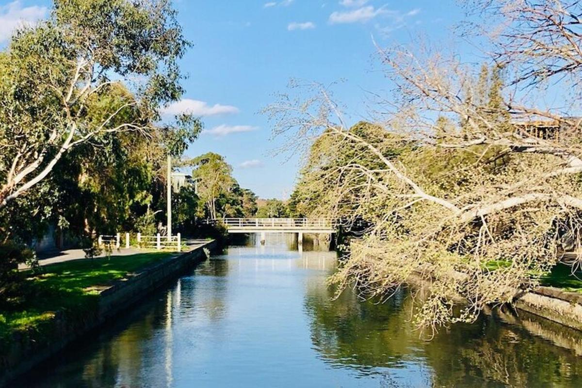 a view of a river with a bridge in the background