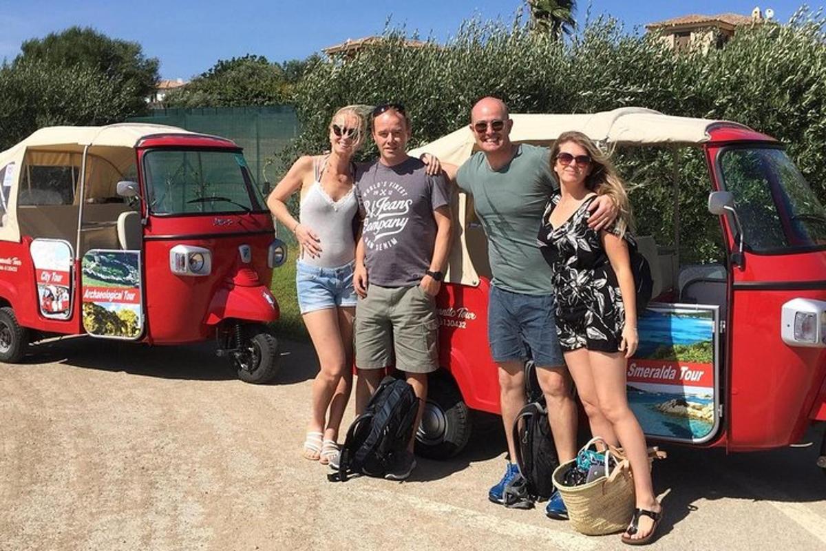 a group of people standing next to a red van