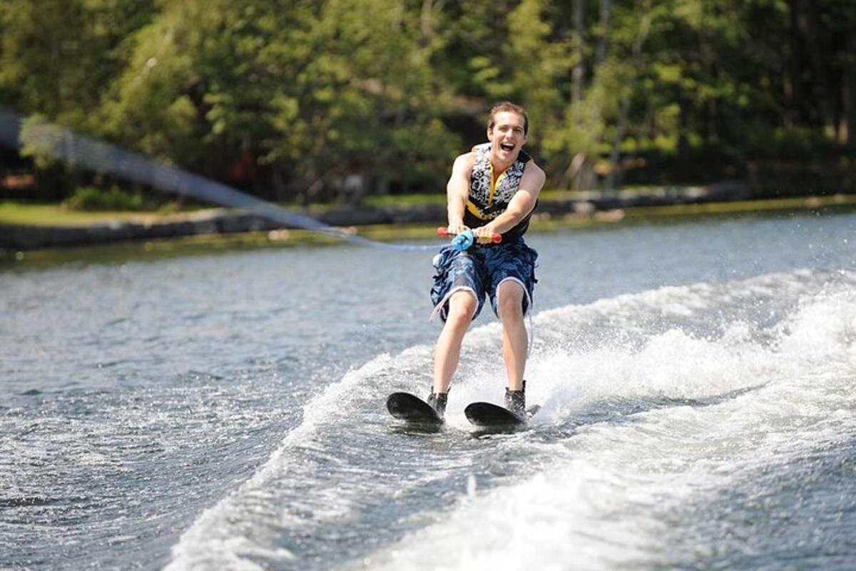 a young boy water skiing on a lake