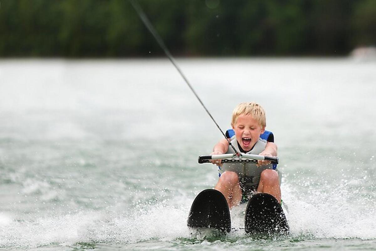 a young boy on water skis in the water