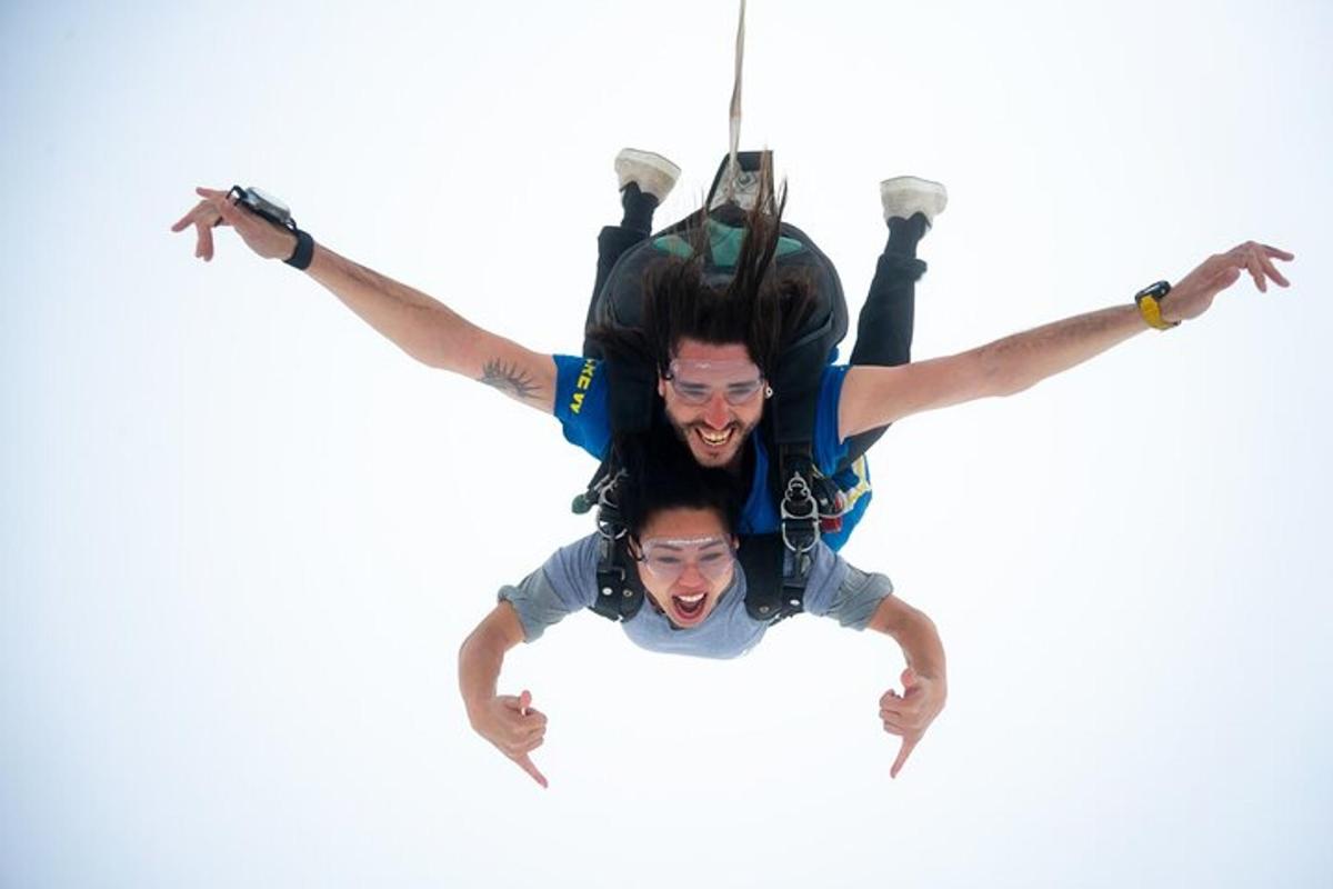 two men are hanging on a rope in the air