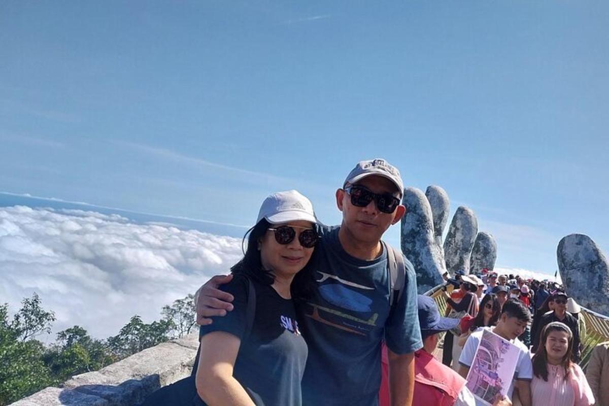 a man and a woman standing on top of a mountain
