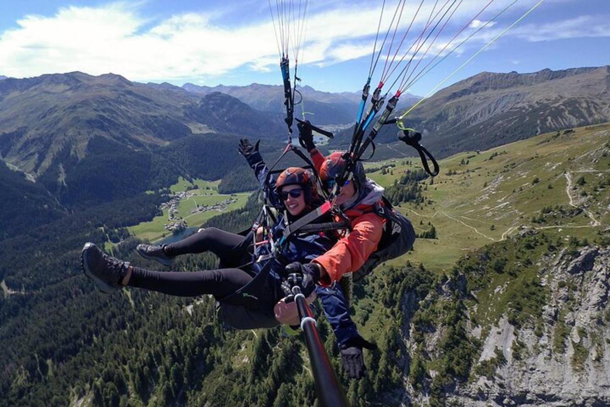 zwei Personen fliegen mit einem Fallschirm durch die Luft