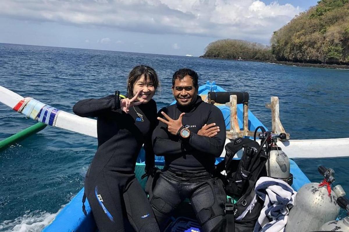 a man and woman on a boat in the water