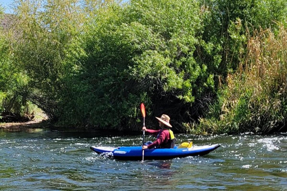 a man in a kayak on a river