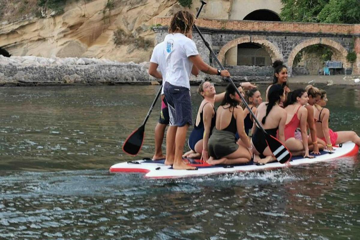 a group of people on a paddle board in the water