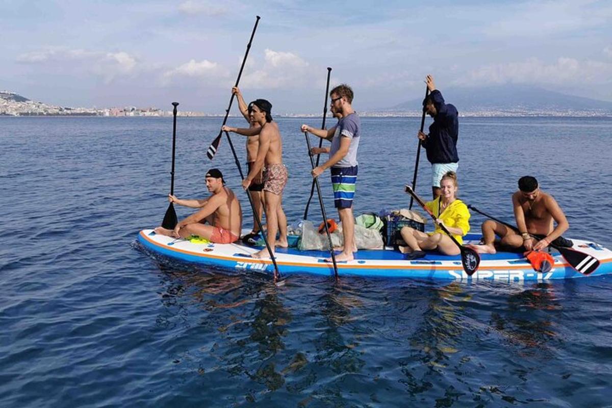 a group of people on a paddle board in the water