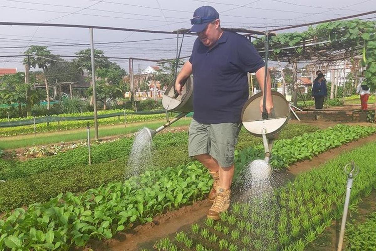 a man standing in a field sprinkling crops