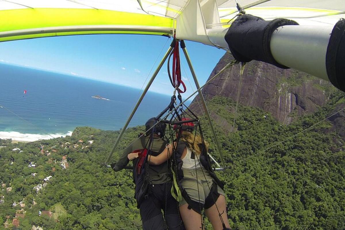 two people hanging from the side of a parachute