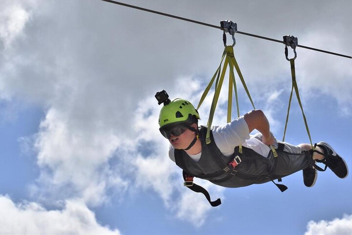 osoba v helmě visící na zipline