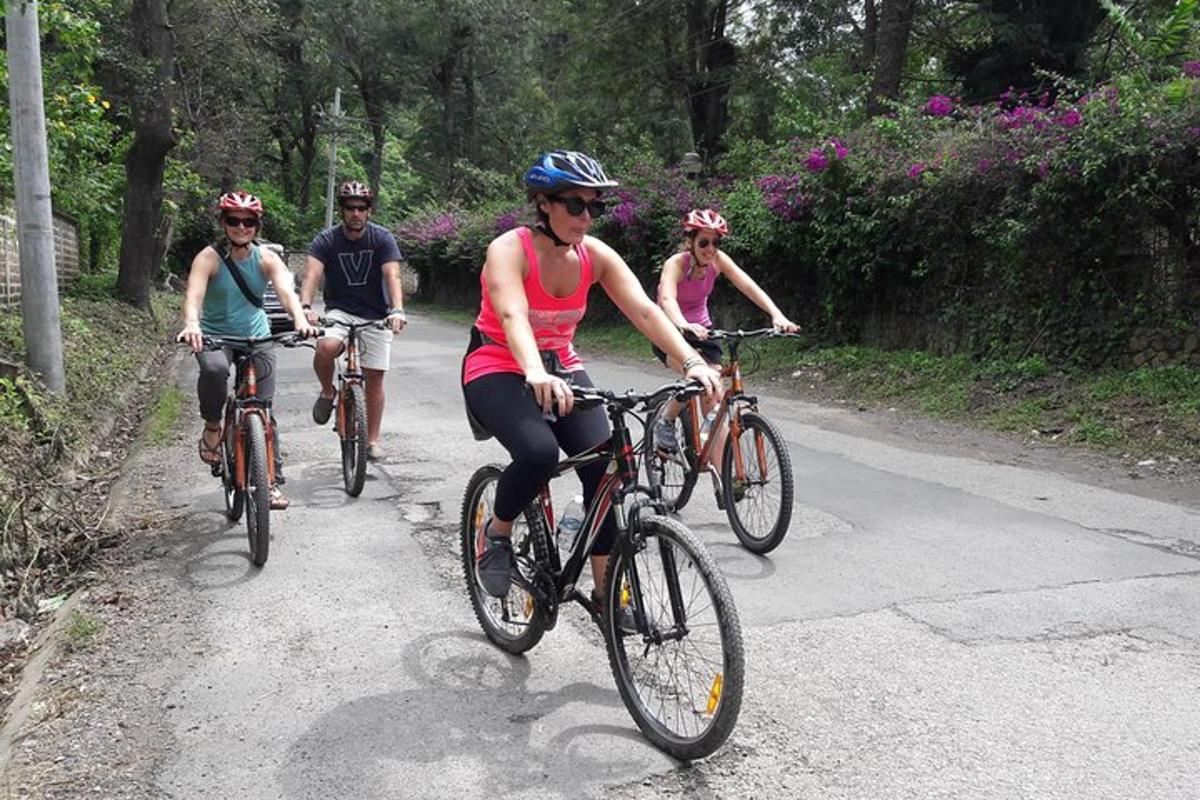 a group of people riding bikes down a road