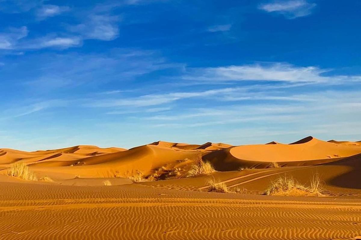 صحراء ذات كثبان رملية وسماء زرقاء