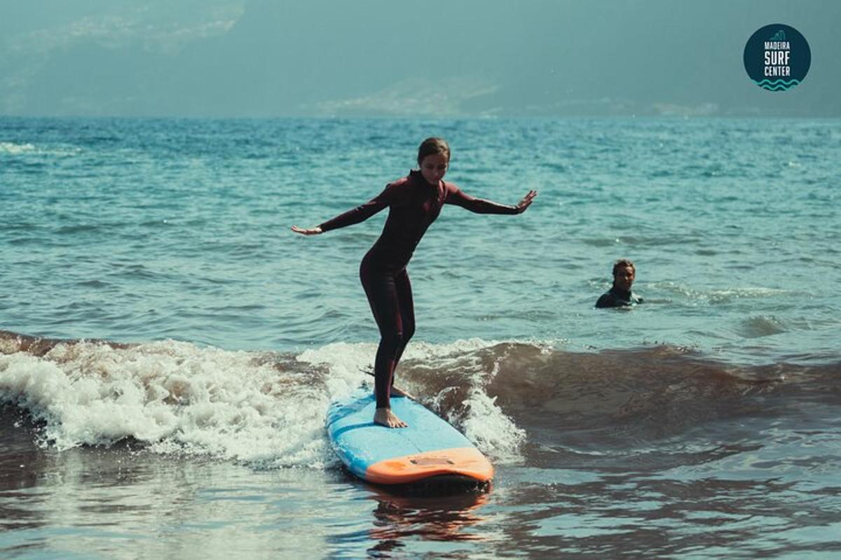 una dona cavalcant una onada sobre una taula de surf a l'oceà