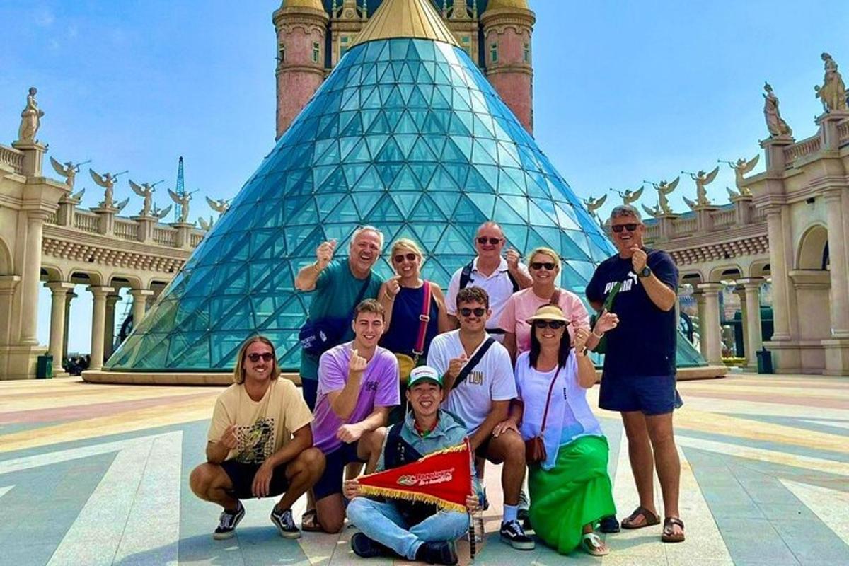 a group of people posing for a picture in front of a building