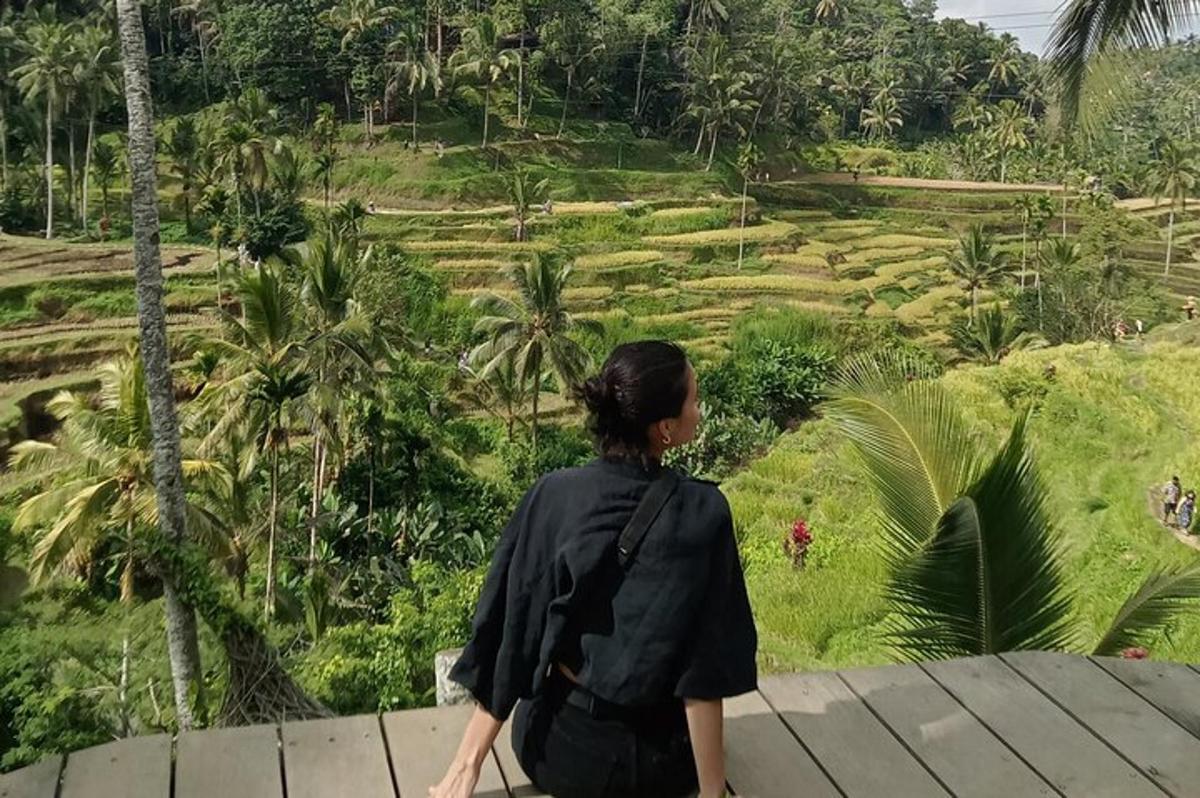 a woman walking on a bridge looking at a field