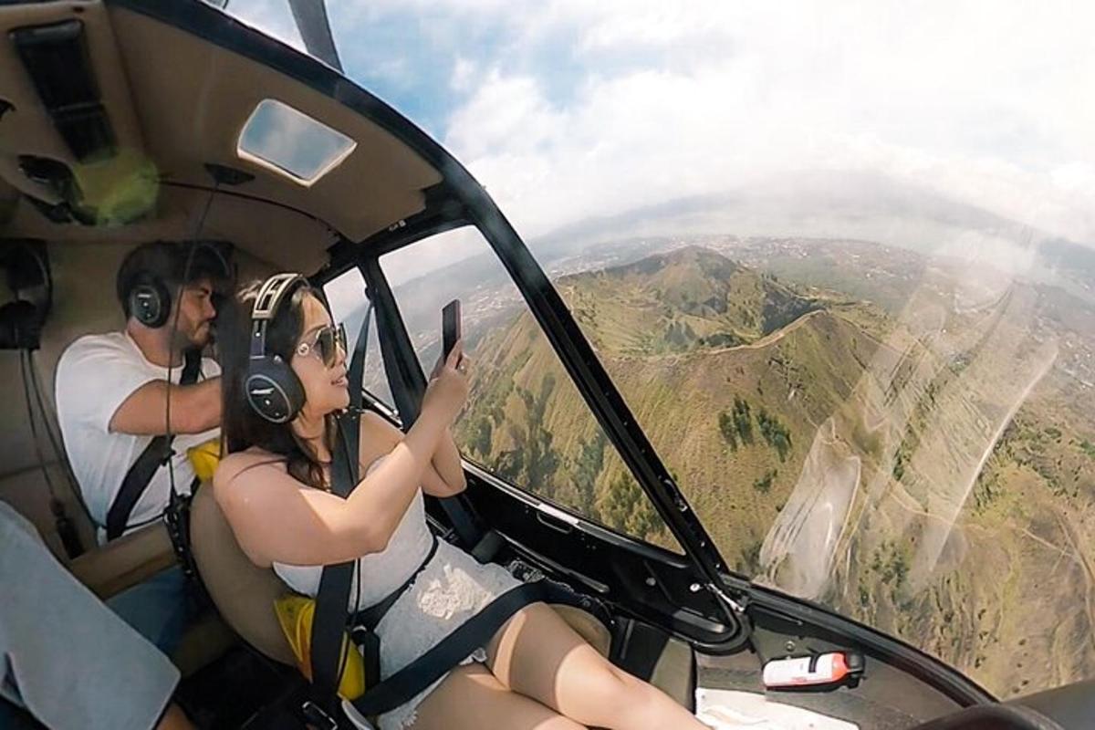 a man and a woman sitting in the cockpit of a helicopter