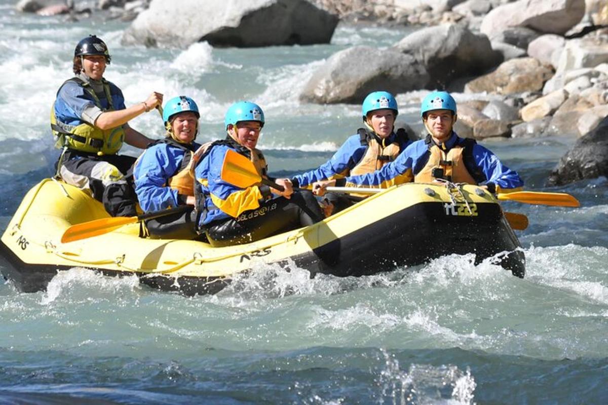 a group of people in a raft in the water