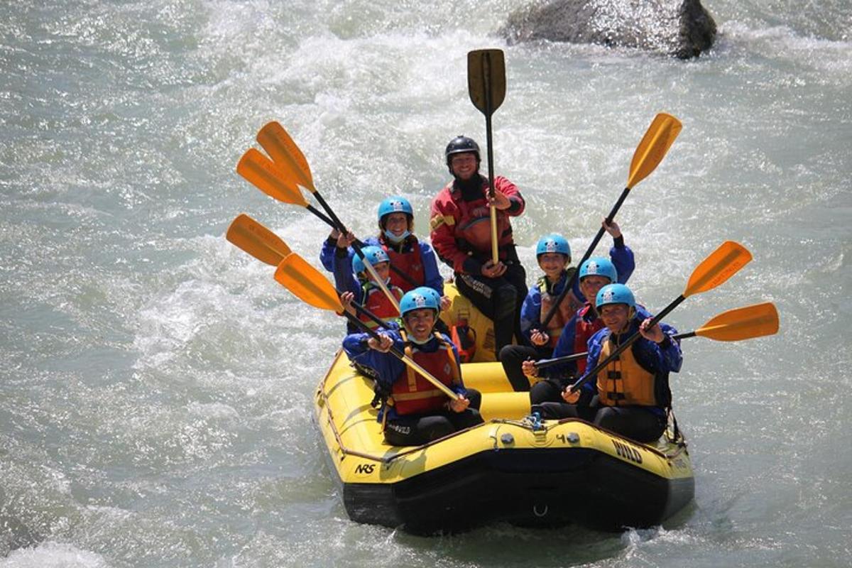 a group of people in a raft in the water