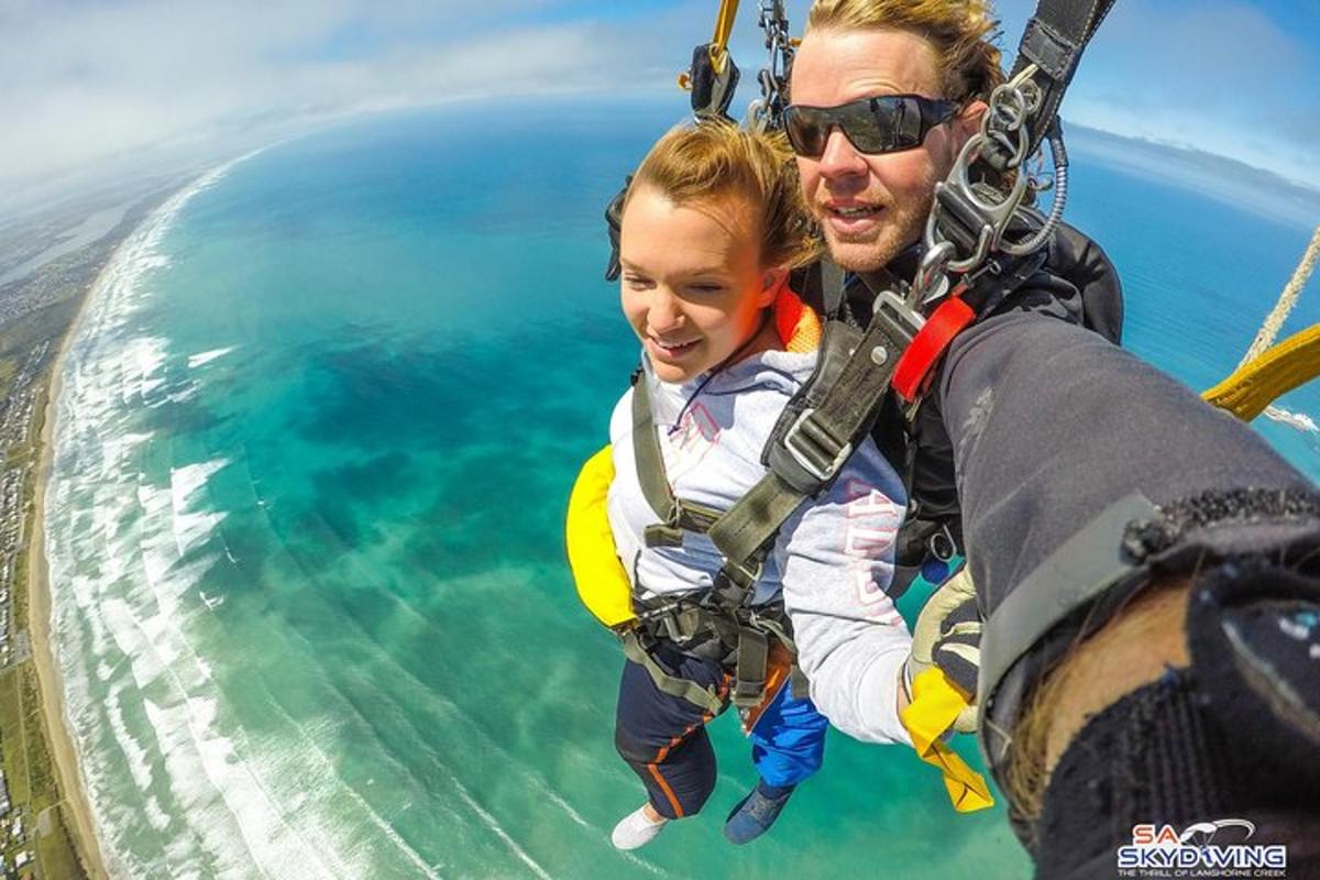 a man and a little girl in a swing in the sky