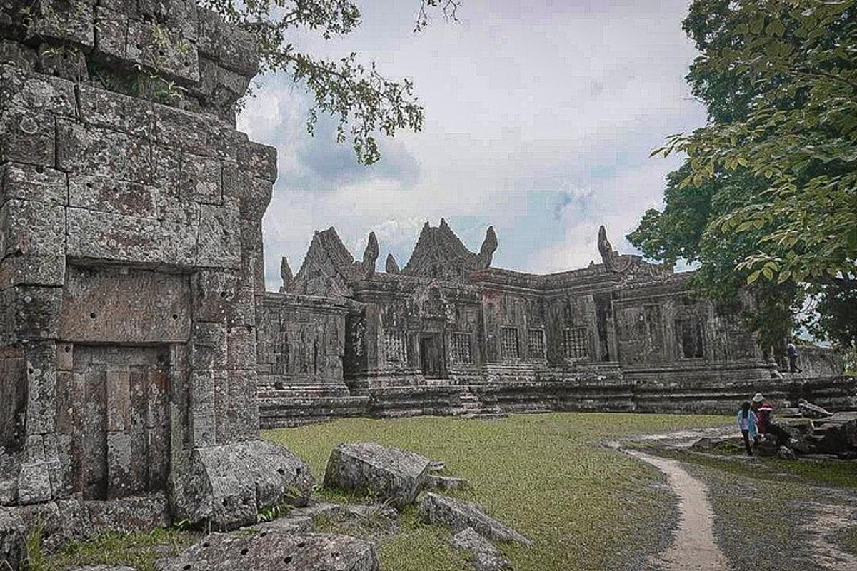 an old building with people standing in front of it