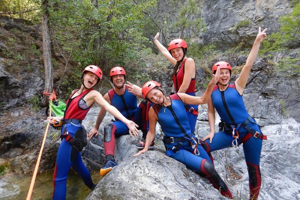 a group of people sitting on a rock on a river