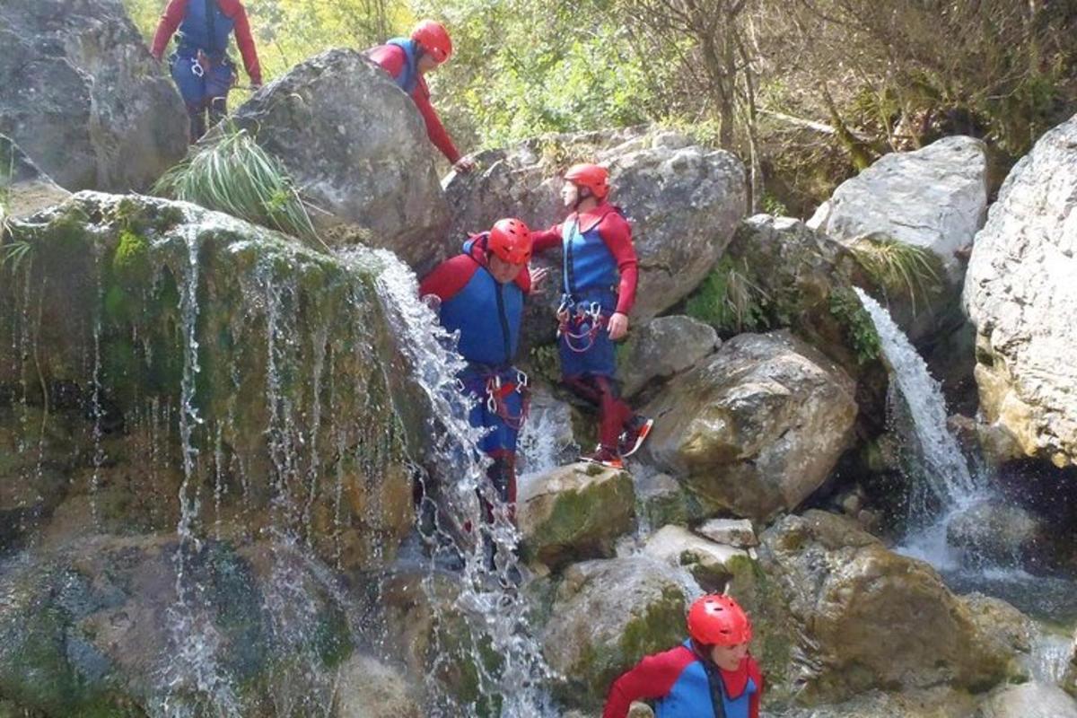 a group of people standing at the top of a waterfall