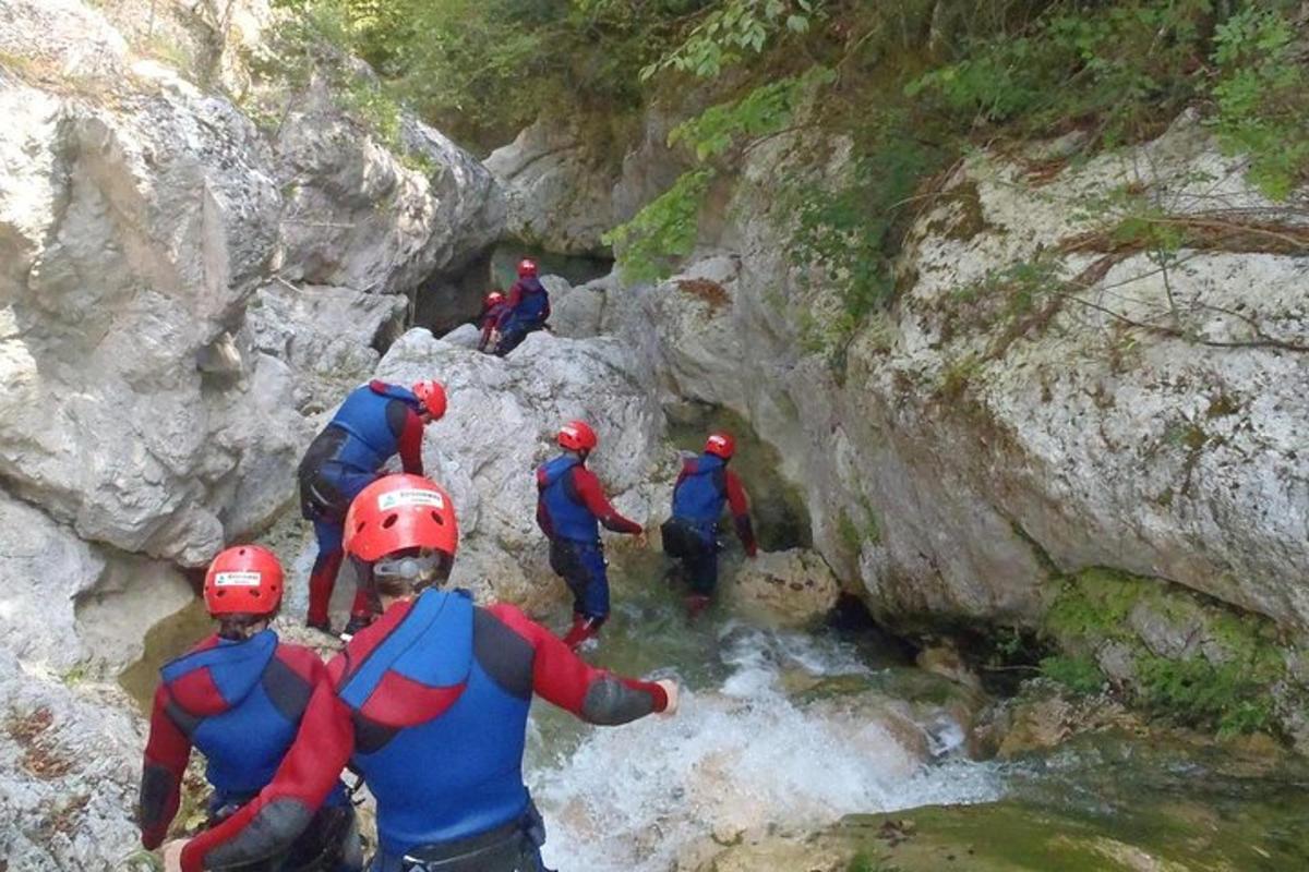 a group of people walking through a river