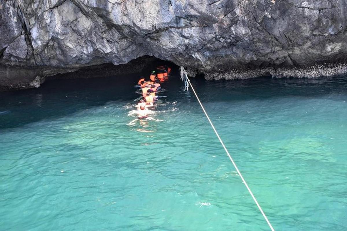 a group of people in the water in a cave